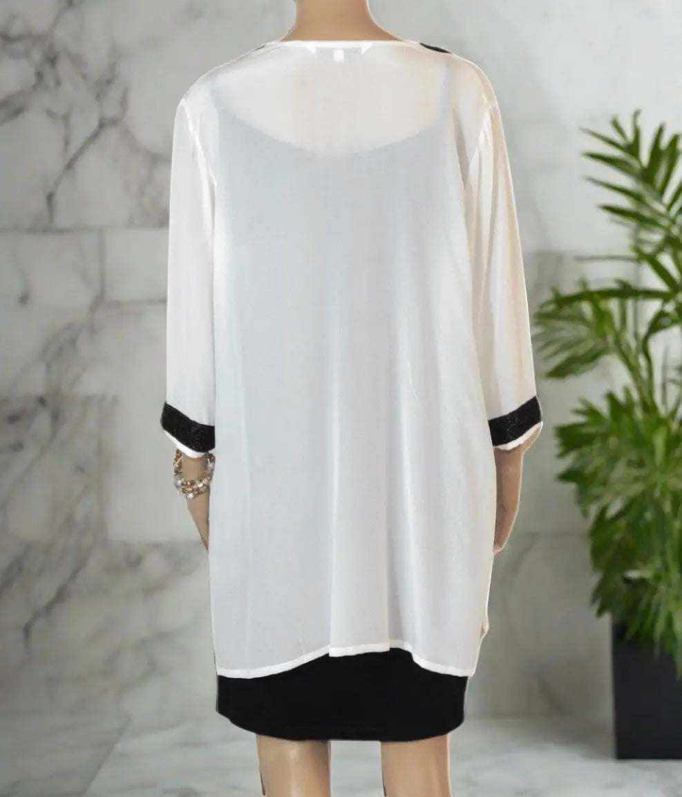 Back view of cream silk beaded tunic top with black bead detailing on sleeves and hem