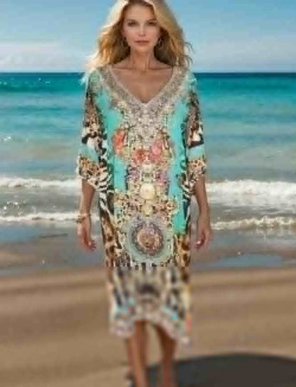 woman wearing sleeve silk embellished dress with animal print and beadwork standing on beach