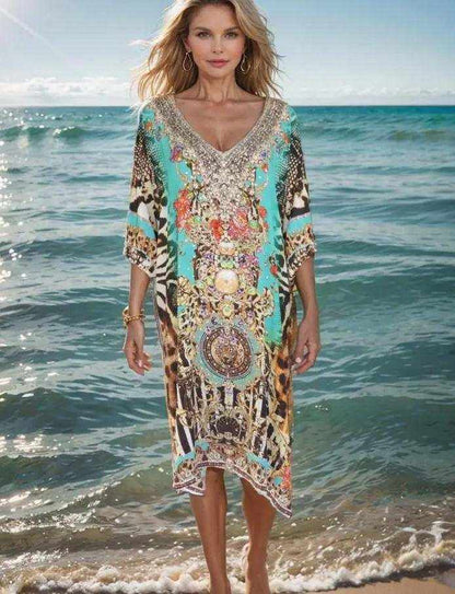 Woman wearing sleeve silk embellished dress with animal print and beadwork standing by the sea