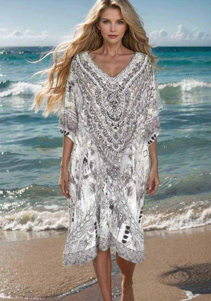 34 sleeve silk embellished dress with gold and silver beadwork on beach background