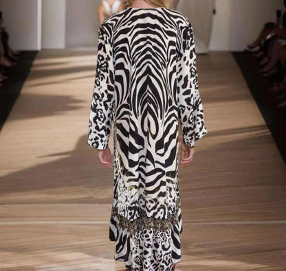 Back view of Silk Hi-Low Frill Dress in black and white animal print with frilled hemline and long split cuff sleeves.