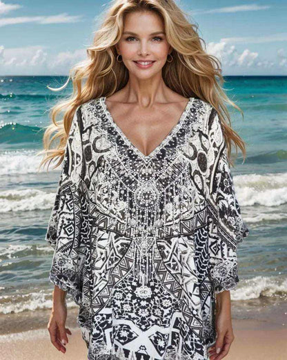 Woman wearing black and white Silk Embellished Butterfly Top with handsewn beadwork and V-neck at the beach