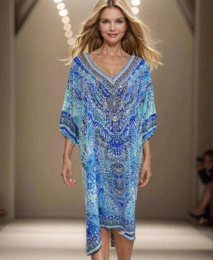 Woman modeling 3/4 sleeve silk embellished dress in Egyptian blue with beadwork and V-neck design