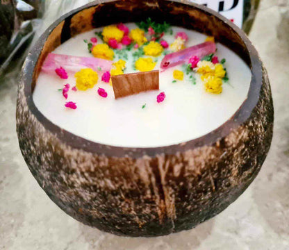 Reclaimed Coconut Shell Candle with wood wick and dried flowers in a natural coconut shell container