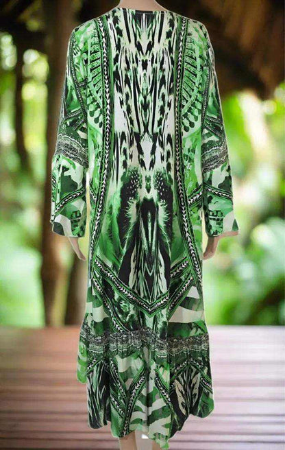 Green patterned silk hi-low dress with long sleeves and frilled hemline viewed from back