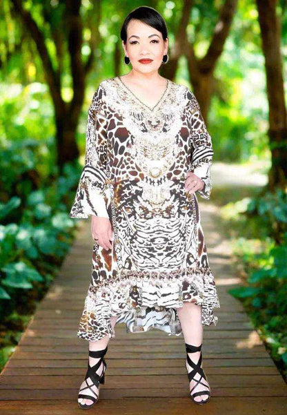 Woman wearing animal print silk hi-low frill dress with long split sleeves and beaded embellishments