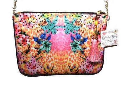 Colorful embellished clutch bag with hibiscus print, zipper closure, tassel, and detachable gold chain by Kaftans that Bling