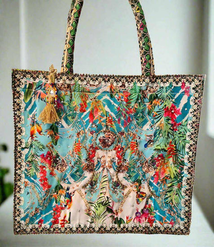 Large Embellished Tote Bag with colorful floral and bird print, padded handles, and tassel charm detail