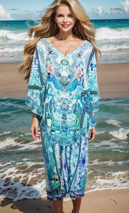 Woman wearing Australian designed Silk Harem Pants in blue-green hues with hand-sewn white and silver beadwork on the beach