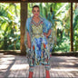 Woman wearing Paradise Blue Silk Harem Pants with hand sewn beadwork and colorful print in a natural outdoor setting