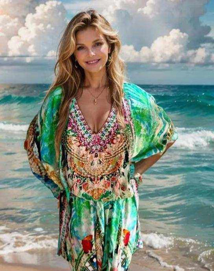 woman wearing Paradise green silk harem pants with colorful print standing on the beach