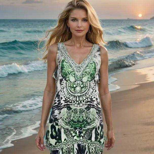 Woman wearing Garbo green silk cami with beadwork and animal print on beach at sunset