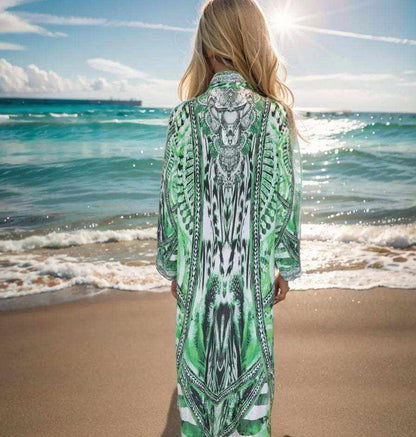 Saffron green long silk embellished jacket with intricate beadwork, worn by woman on beach back view