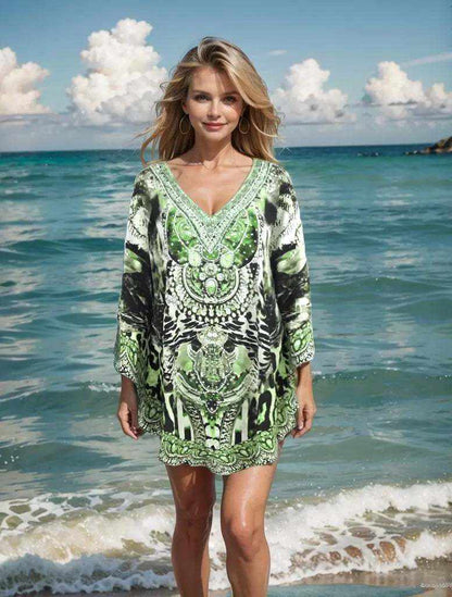 Woman wearing Garbo Green Silk Embellished Butterfly Top with beadwork standing by the ocean