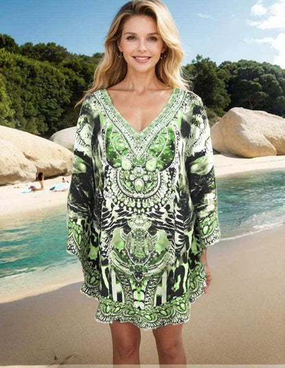 Woman wearing Garbo Green Silk Embellished Butterfly Top with beadwork and butterfly sleeves on beach background