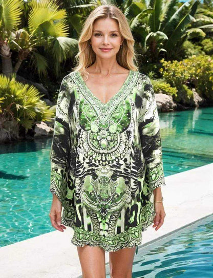 Silk Embellished Butterfly Top in Garbo Green with handsewn beadwork and butterfly sleeves modeled by woman near pool