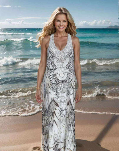 Woman wearing hand-embellished Tahiti Dream Silk Maxi Dress with silver beadwork on beach background