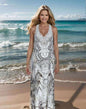 Woman wearing hand-embellished Tahiti Dream Silk Maxi Dress with silver beadwork on beach background