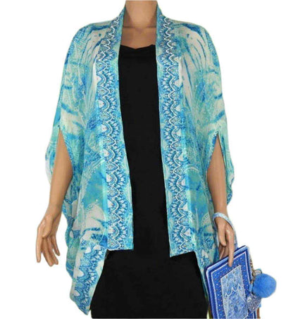 blue and white silk cape cover-up with Tahitian print and beadwork over black dress