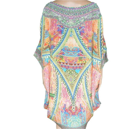 Colorful silk embellished hi-low kaftan top with intricate patterns and hand-sewn beadwork, luxurious resort wear.