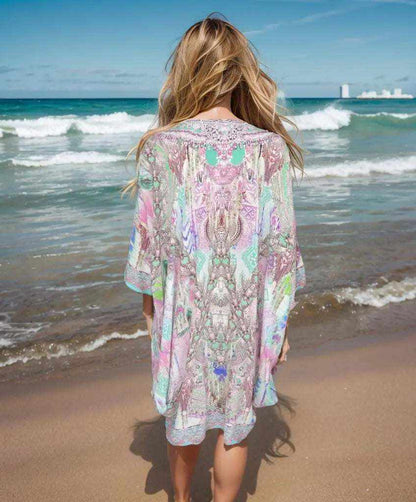 Back view of Zahara Silk Batwing Kaftan Top with hand-embellished beadwork worn at the beach