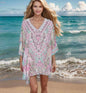 Woman wearing Zahara Silk Batwing Kaftan Top with hand-embellished beadwork by the beach