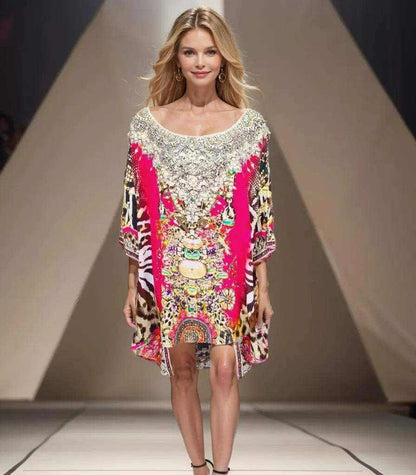 Woman wearing red silk kaftan batwing top with intricate beadwork and animal print on runway