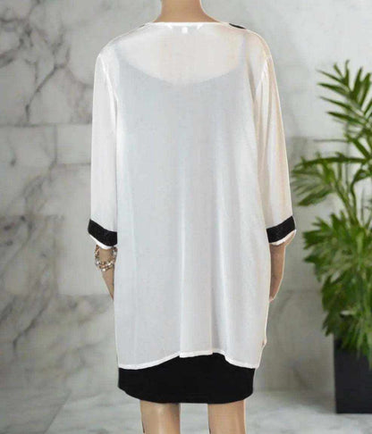 Back view of cream silk beaded tunic top with black bead detailing on sleeves and hem