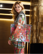 Large Embellished Tote Bag with vibrant floral print and padded handles carried by smiling woman