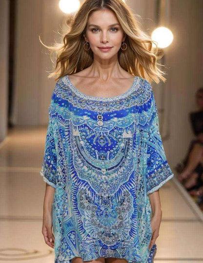 Blue silk kaftan top with embellishments. Hi-low style.