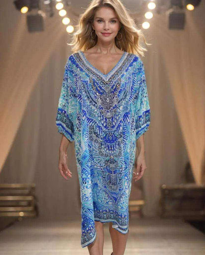 Woman wearing 3/4 sleeve silk embellished dress in Egyptian blue with beadwork and side splits