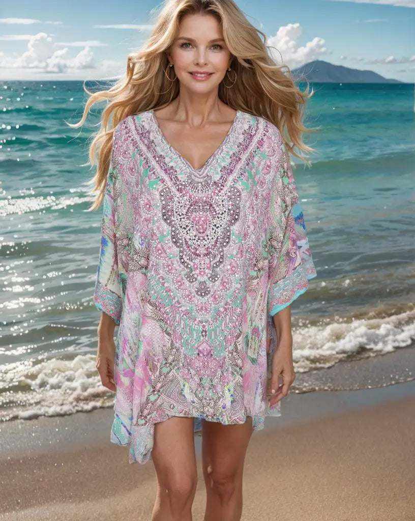 Woman wearing Zahara Silk Batwing Kaftan Top with hand-embellished beadwork on beach background