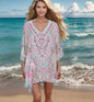 Woman wearing Zahara Silk Batwing Kaftan Top with hand-embellished beadwork by the beach