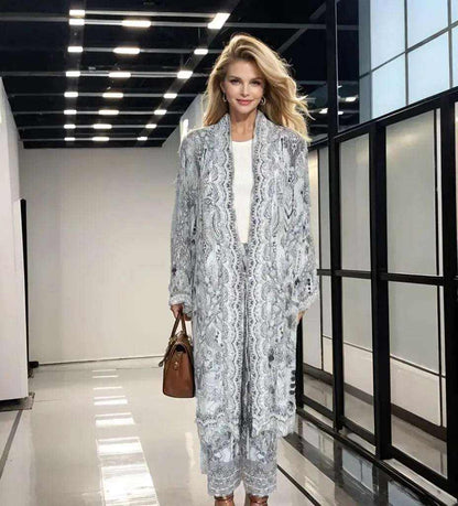 Woman wearing silk embellished palazzo pants and matching kimono jacket in soft grey with intricate beadwork details