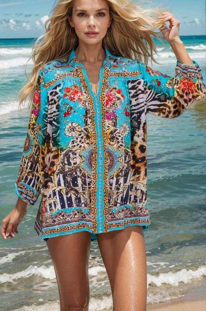 Woman wearing aqua animal print Garden Delight Silk embellished shirt by Fashion Spectrum at the beach