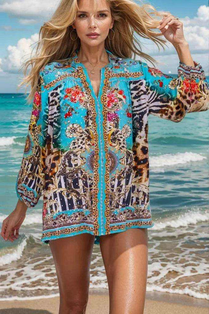Woman wearing aqua animal print Garden Delight Silk embellished shirt by Fashion Spectrum at the beach