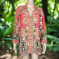 Garden Delight red silk embellished shirt with animal print and intricate beading on mannequin outdoors