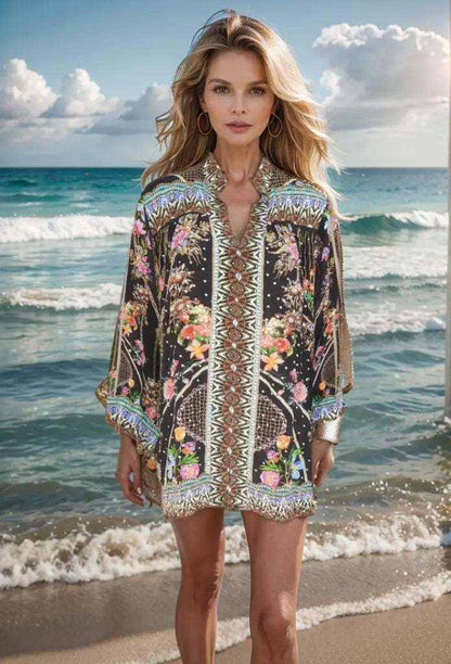Black silk embellished shirt-capri with floral patterns and intricate gold and silver beading worn by model on beach background