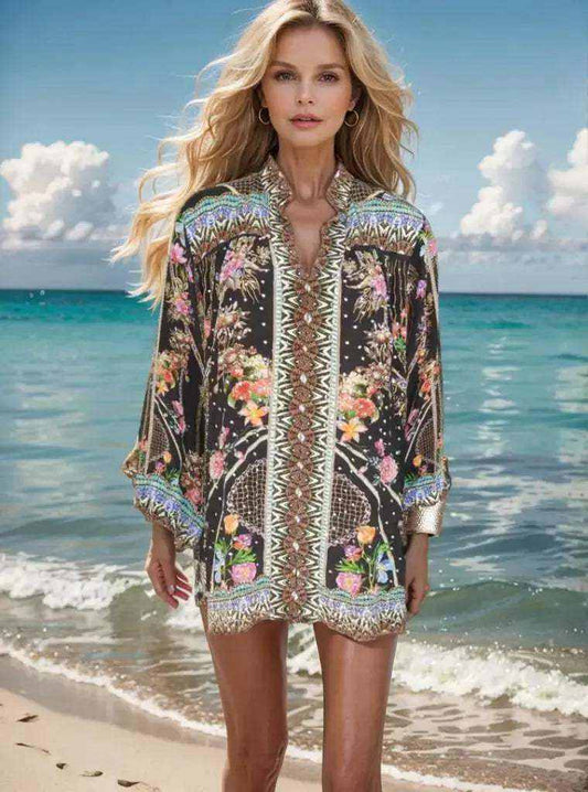 Woman wearing black floral silk embellished shirt-capri standing on beach with ocean background