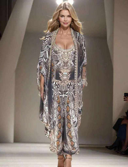 Model wearing silk embellished wrap pants with cobra snake print and handsewn beadwork on runway