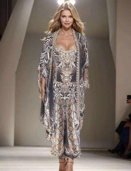 Model wearing silk embellished wrap pants with cobra snake print and handsewn beadwork on runway