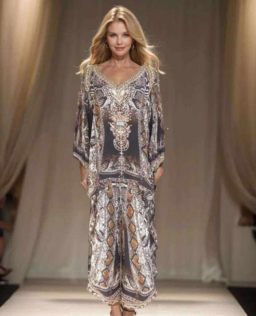 woman wearing silk embellished wrap pants with cobra snake print and beaded embellishments on runway